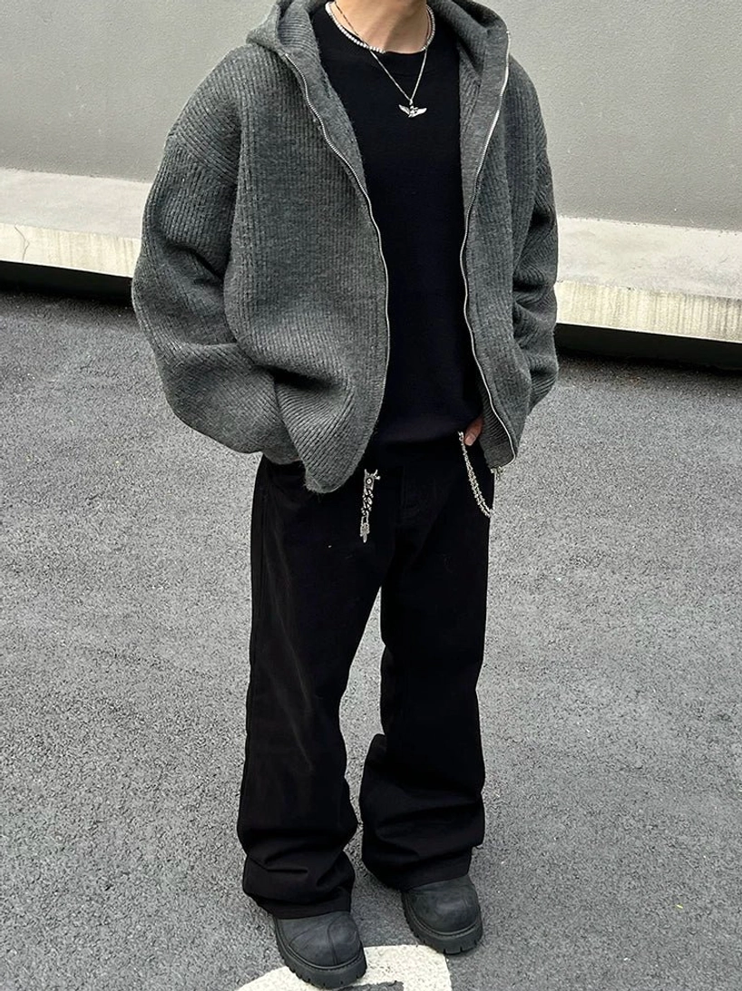 Upper-body view of charcoal grey rib-knit zip hoodie showing dropped shoulders wide sleeves full metal zipper and textured knit fabric
