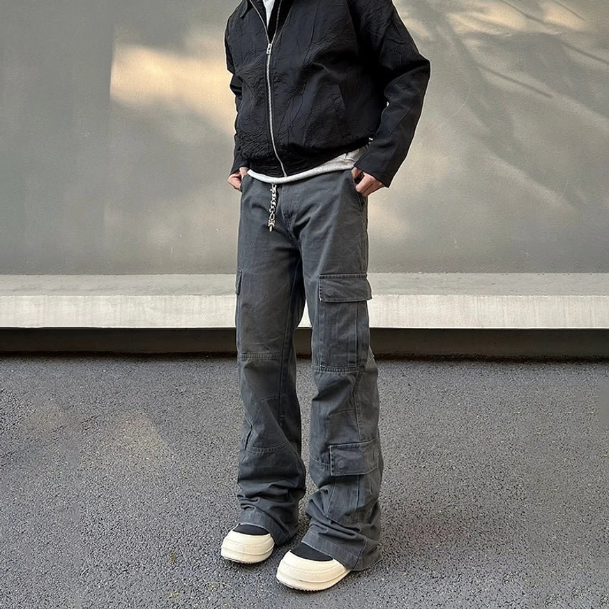 Men's charcoal haze utility cargo pants front view with drawstring waist wide flared legs and stacked sneaker hems