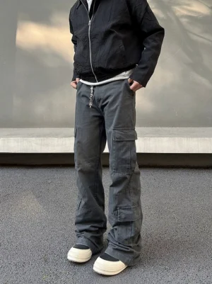 Men's charcoal haze wide leg utility cargo pants front full body streetwear outfit with black zip jacket and chunky sneakers