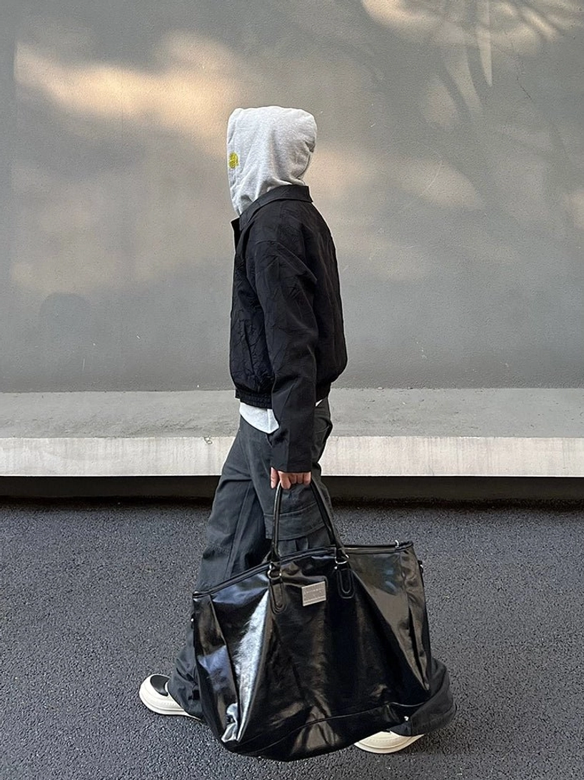 Three quarter rear view of washed charcoal gray wide leg cargo pants with utility pocket layout and loose streetwear fit