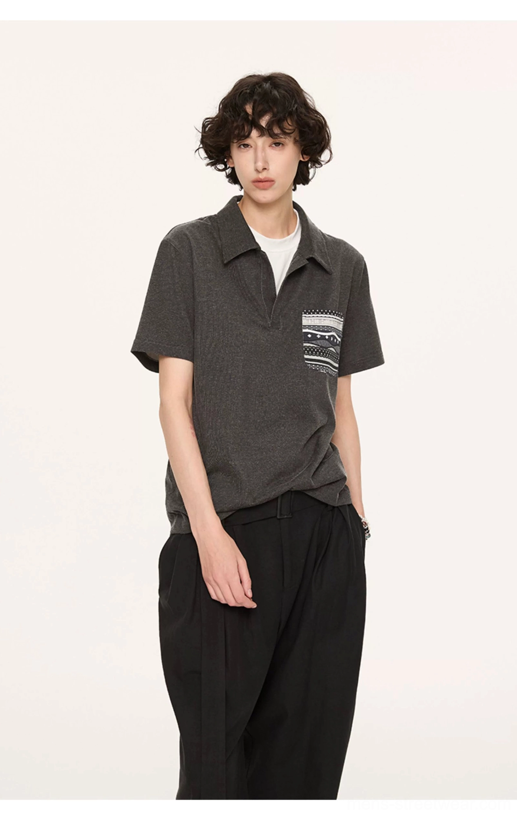Charcoal layered collar polo shirt with patterned chest pocket styled over a white undershirt in studio