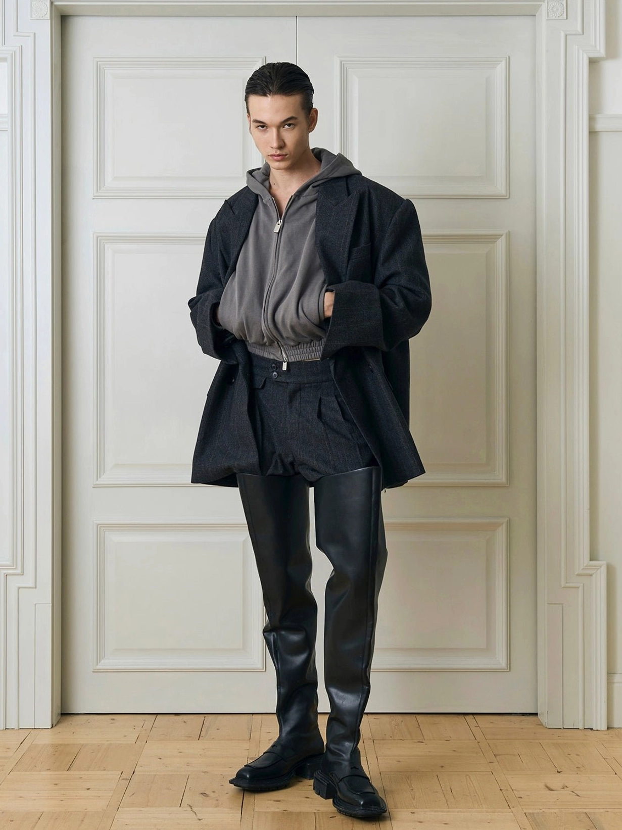 Oversized charcoal double-breasted blazer layered over grey half-zip hoodie in Korean streetwear outfit