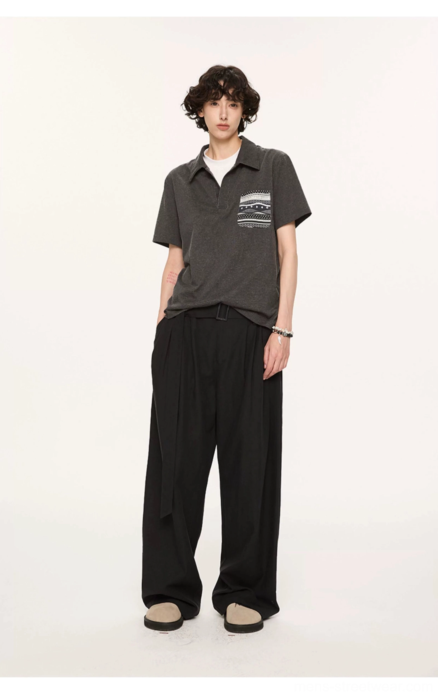 Full front view of charcoal relaxed knit polo with Fair Isle chest pocket paired with black wide leg pants and loafers