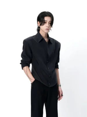 Front three-quarter view of a male model wearing a charcoal sculpted waist button-up shirt with black wide-leg trousers in an avant-garde Korean streetwear outfit
