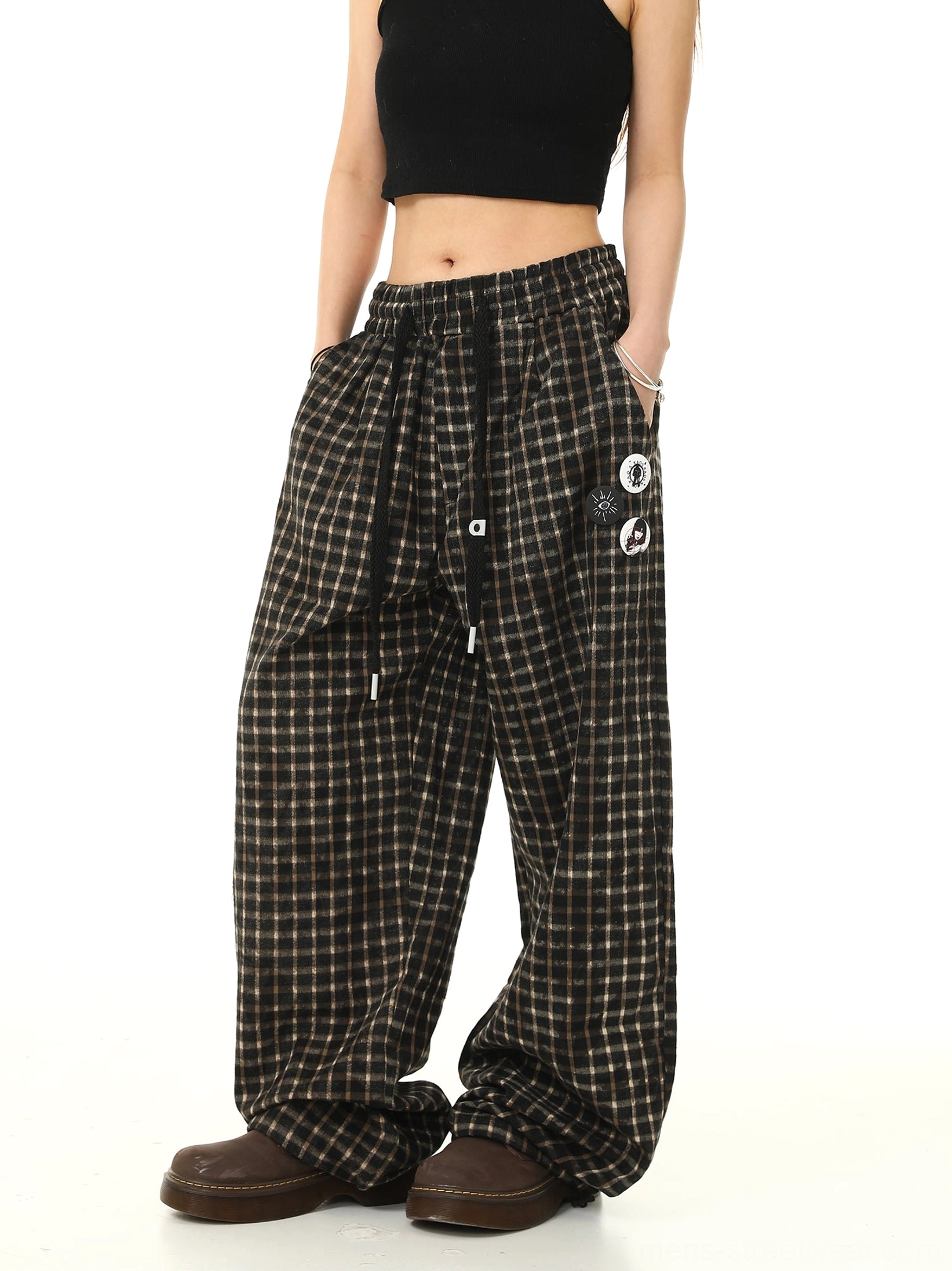 Side view of wide leg check print streetwear pants with decorative thigh badges adjustable drawstring waist and side pocket