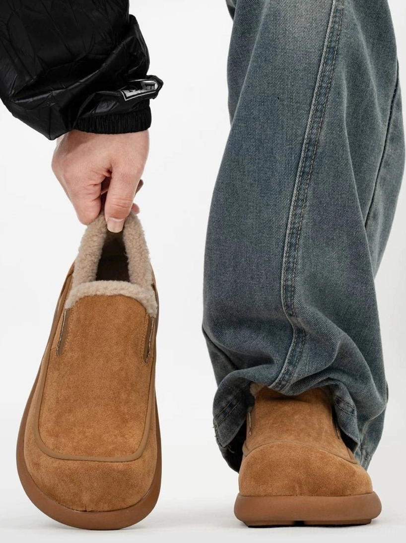 Chestnut brown shearling clogs shown from front and rear while worn with relaxed baggy jeans, featuring a minimalist round-toe slip-on silhouette