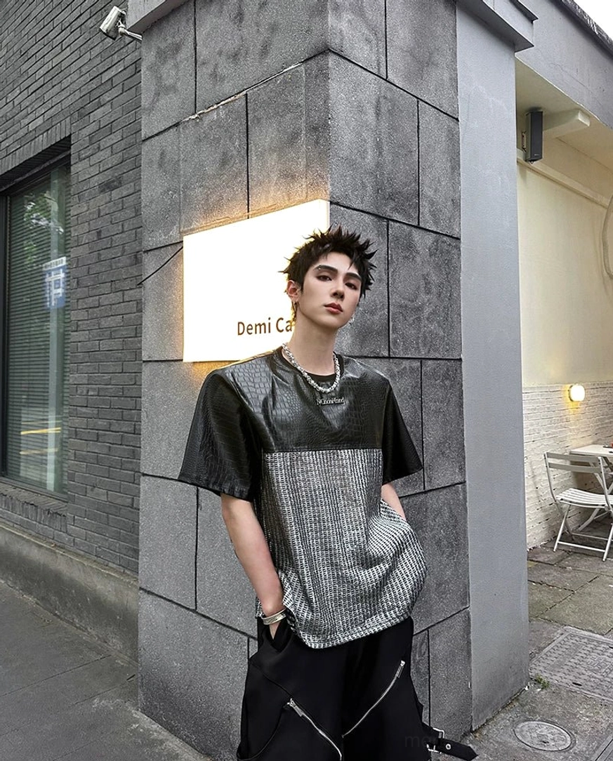 Black chrome grid patchwork techwear T-shirt with crocodile-effect upper panels, silver textured torso, and bold avant-garde streetwear design