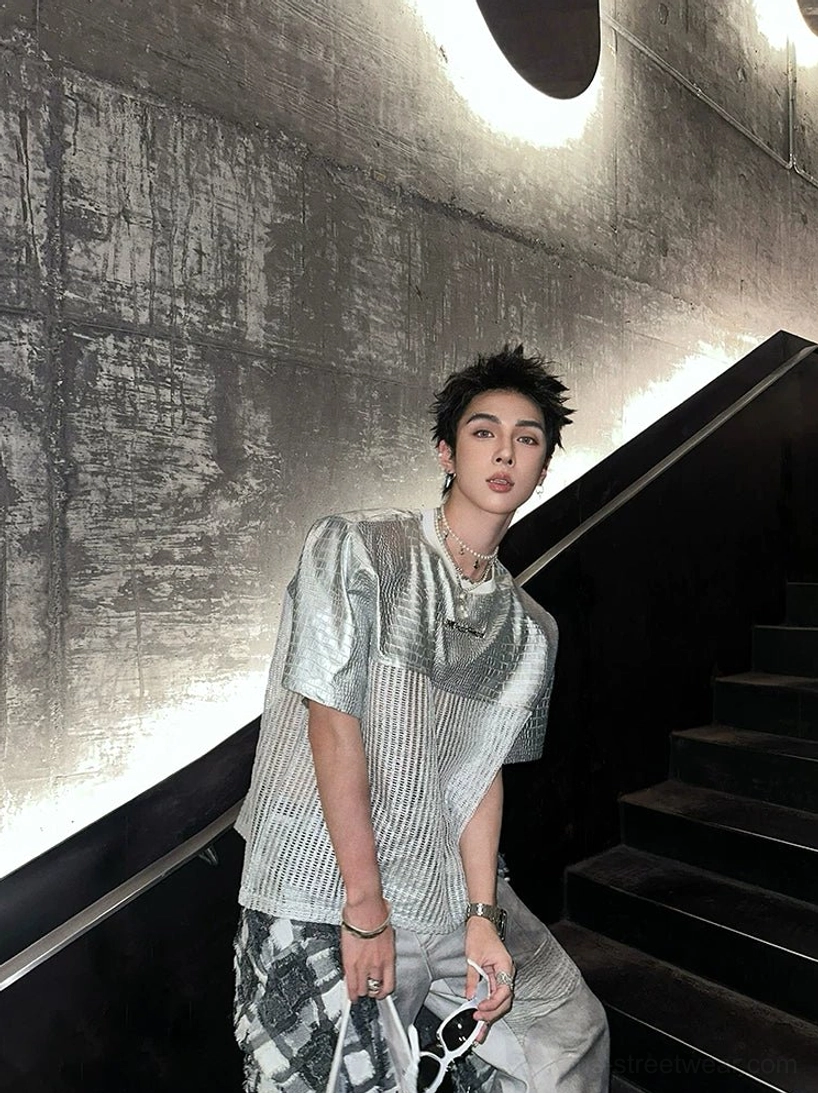 Side three-quarter view of the metallic silver chrome grid patchwork techwear T-shirt with smooth upper panels and textured body