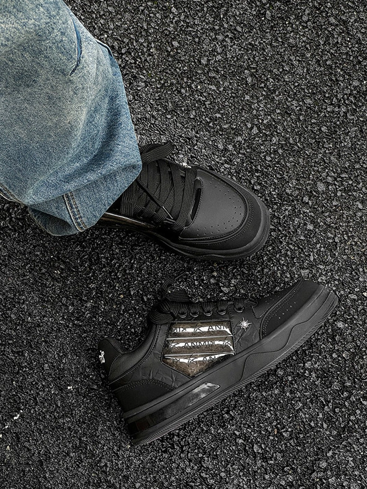 Chunky black gothic skate sneakers with metallic silver side accents and statement star details for dark streetwear outfits
