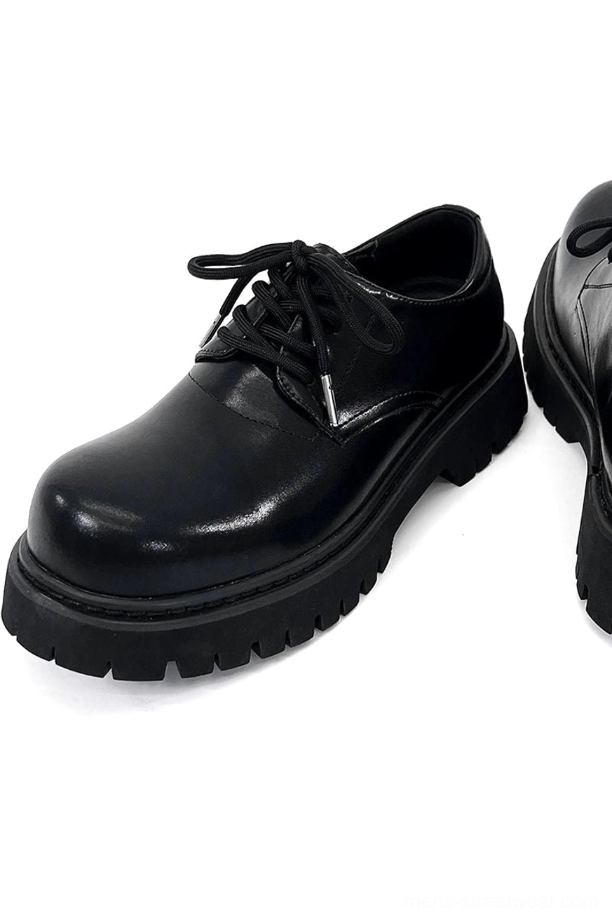 Chunky black platform footwear with classic derby lacing and versatile monochrome wardrobe appeal