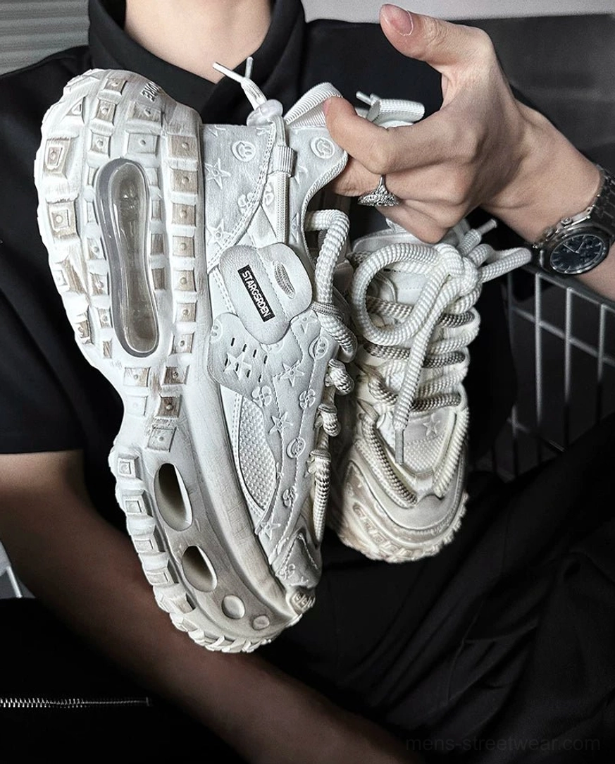 Chunky distressed platform sneakers designed for darkwear and techwear outfits with layered textures and a hollow rubber sole
