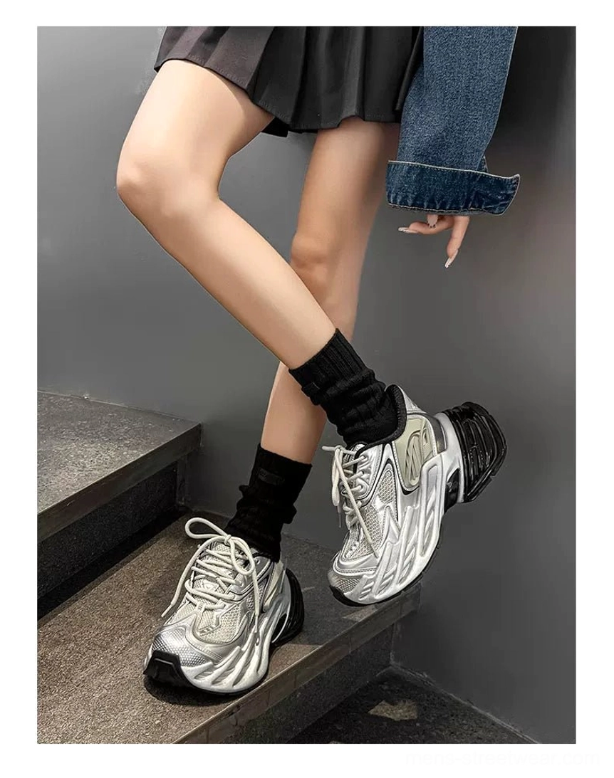 Chunky metallic silver runner sneakers with breathable mesh panels and elevated black platform sole