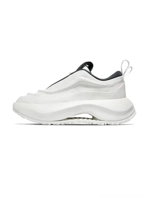 Rear three-quarter view of chunky off-white perforated leather streetwear sneakers with black inner lining, heel pull tab, laceless slip-on-inspired construction, and thick elevated midsole