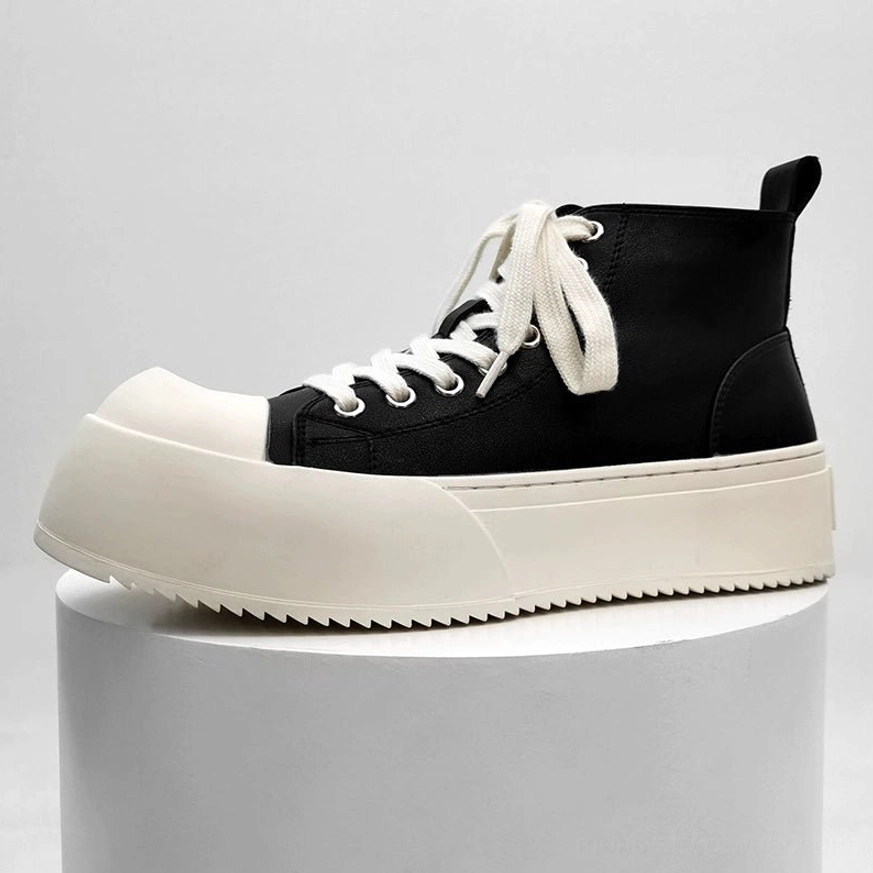 Chunky platform low-top streetwear sneakers with black leather upper, heel pull tab, white flat laces, rounded toe cap, and thick off-white platform sole