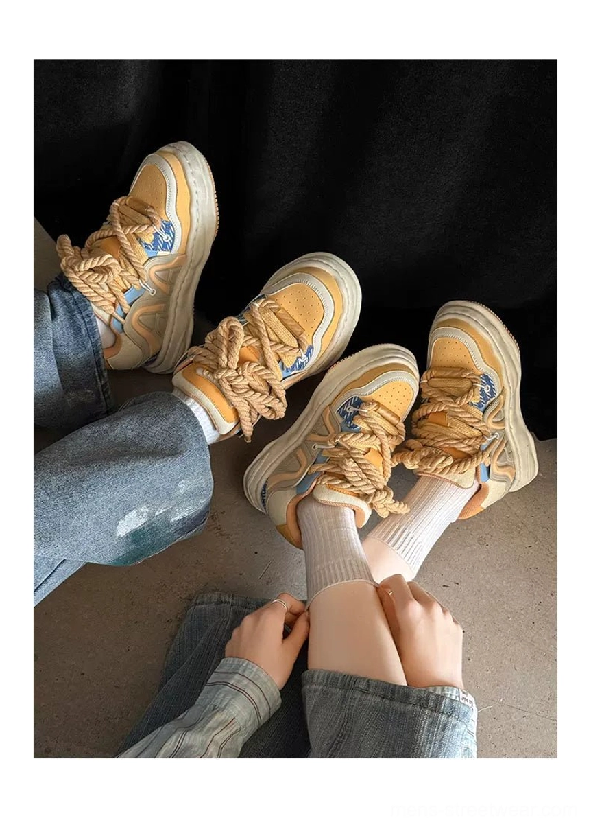 Matching chunky rope lace platform sneakers worn with blue jeans in overhead streetwear styling view