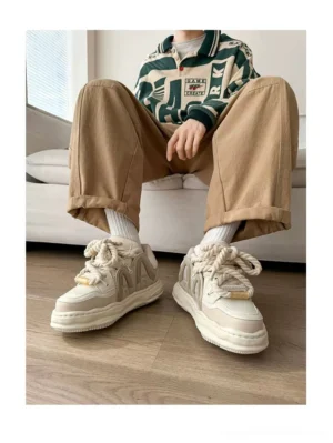 Rice color chunky platform sneakers with thick rope laces worn with khaki cargo pants in Seoul streetwear outfit