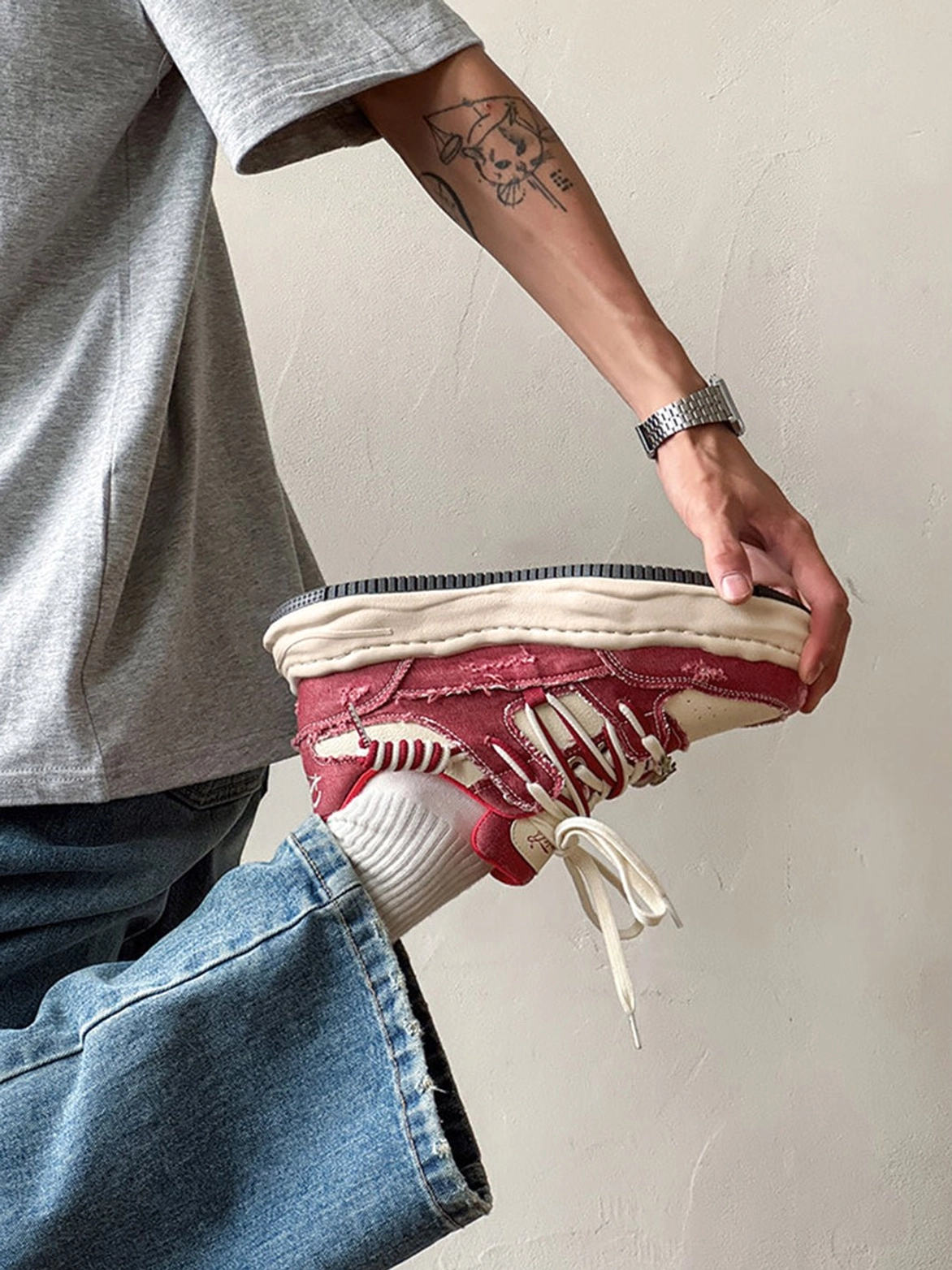 Chunky vintage denim streetwear sneakers with layered lace-up construction and contrasting color-blocked panels