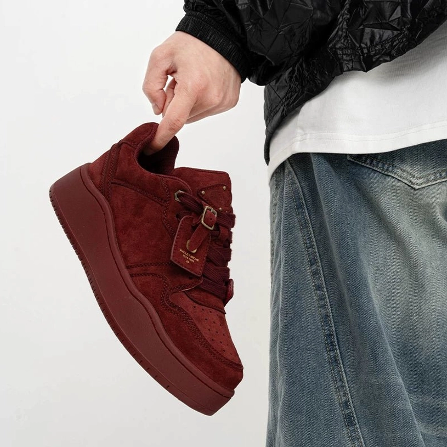 Claret maroon suede platform skate sneaker shown from the side three-quarter angle with leather hanging tag and thick rubber sole
