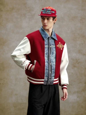 Claret and white denim panel varsity bomber jacket styled with a graphic baseball cap, contrast sleeves and striped ribbed cuffs