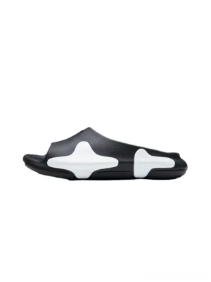 Cloud colorblock slide sandals in black and white with sculpted EVA upper and cushioned wave sole on a white background
