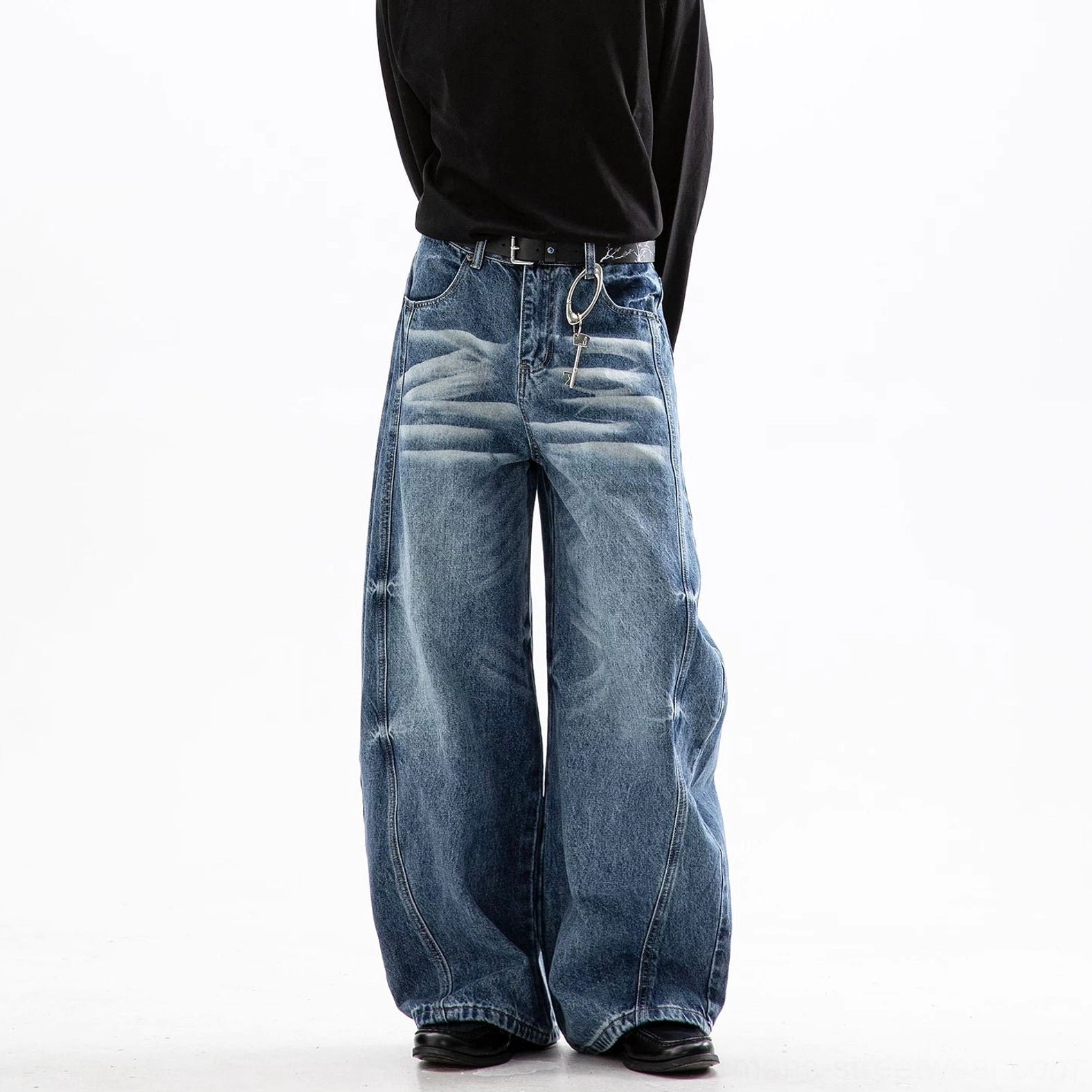 Cloud washed baggy wide leg jeans showing textured faded denim and relaxed straight leg construction