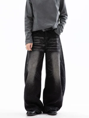 Black cloud washed ultra wide leg jeans shown from the front in a minimalist studio Korean streetwear outfit