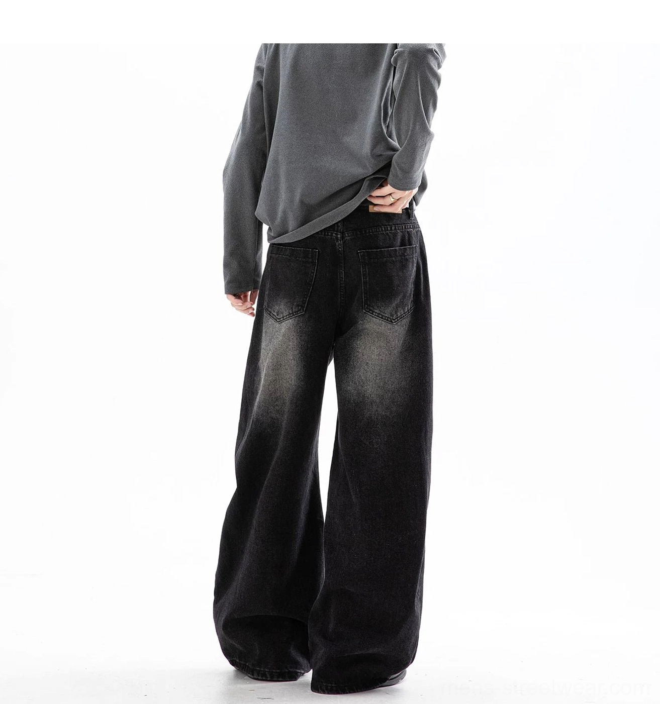 Full back view of black oversized wide leg denim jeans with clean pocket stitching and long stacked legs