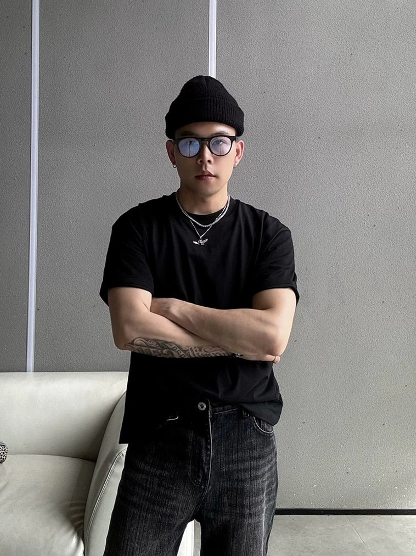 Front three-quarter view of a black boxy crew neck streetwear T-shirt with a clean minimalist silhouette