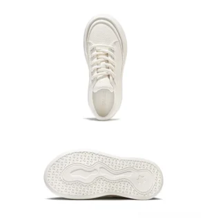 Top view of white minimalist leather platform sneakers with lace-up low-top construction