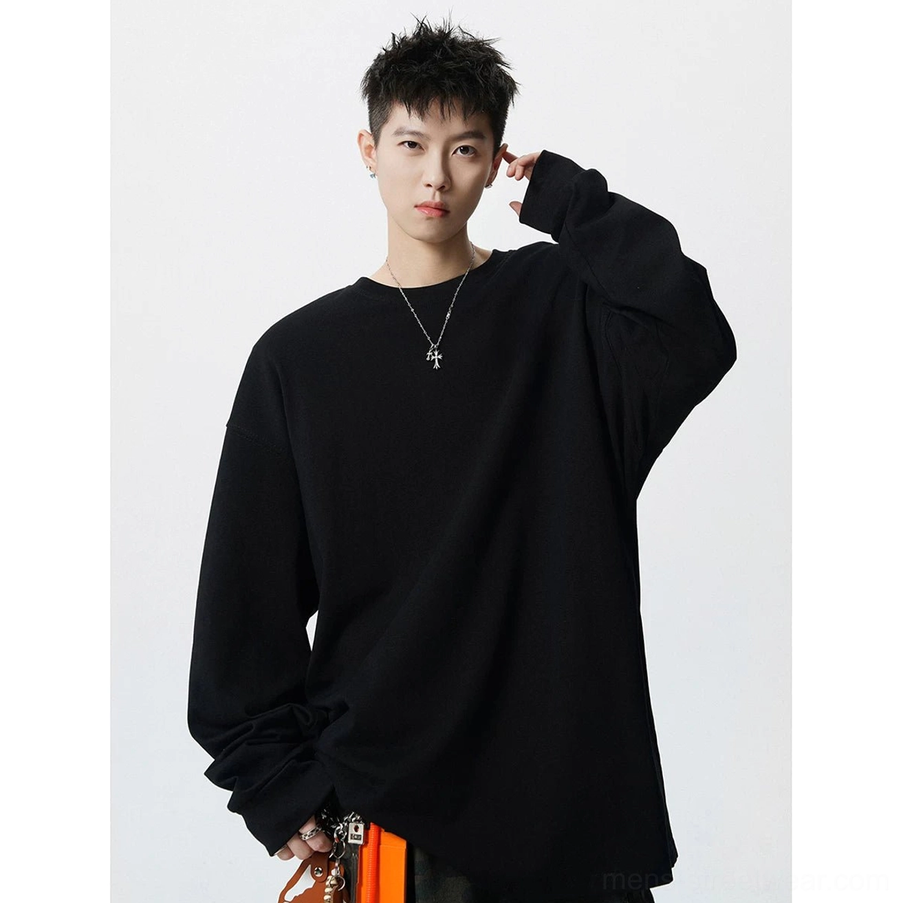 Black oversized drop shoulder long sleeve T-shirt shown in three quarter view with relaxed Seoul streetwear silhouette