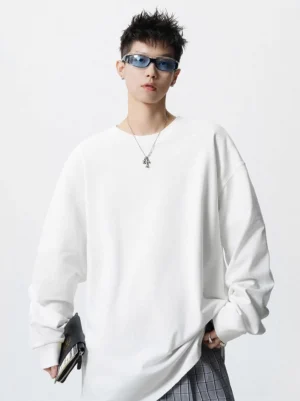 White oversized drop shoulder long sleeve tee shown from the front in a clean Korean minimalist streetwear outfit