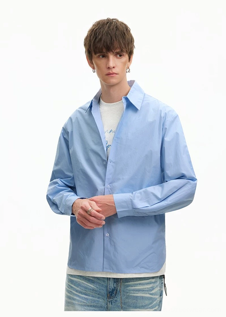 Light Blue oversized poplin shirt with buttoned cuffs and crisp fabric texture styled with casual blue denim