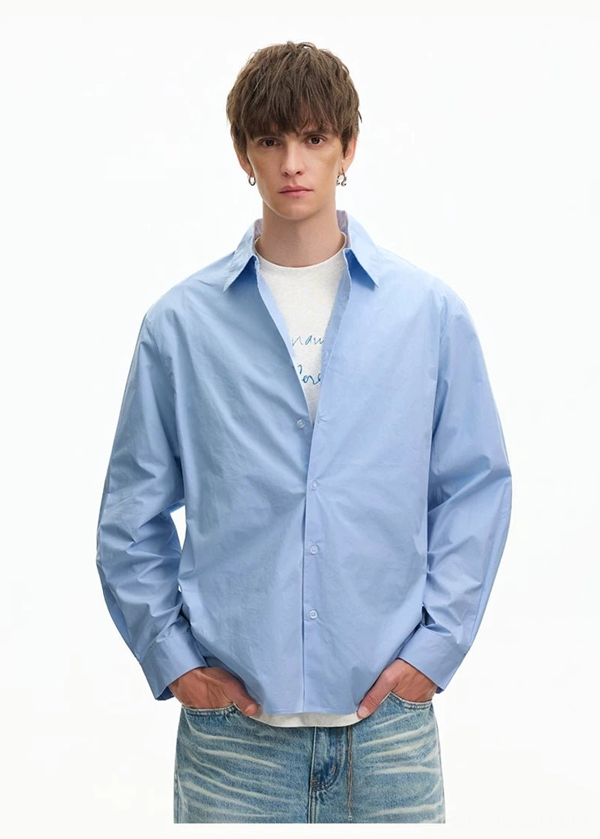 Light Blue oversized poplin shirt worn open over a white undershirt with the collar relaxed for casual Korean fashion styling