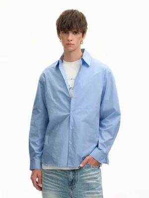 Front full-body view of a Light Blue oversized poplin shirt styled with a white undershirt and faded blue jeans in Korean streetwear fashion