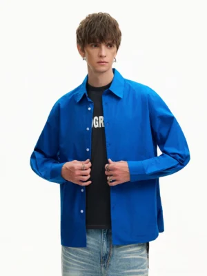 Royal Blue oversized poplin shirt worn open over a black graphic T-shirt with a relaxed Korean streetwear silhouette