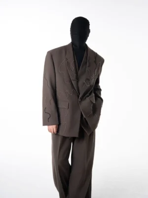 Side front view of coffee brown beaded oversized suit with single-breasted blazer and relaxed wide-leg trousers