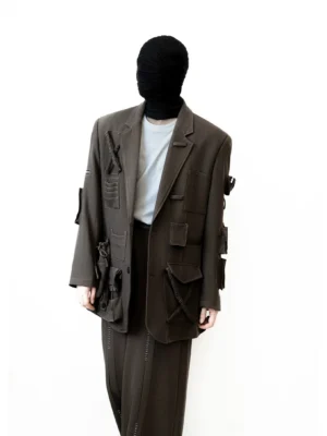 Three-quarter front view of coffee brown oversized utility blazer with asymmetric tactical pockets and tailored lapels