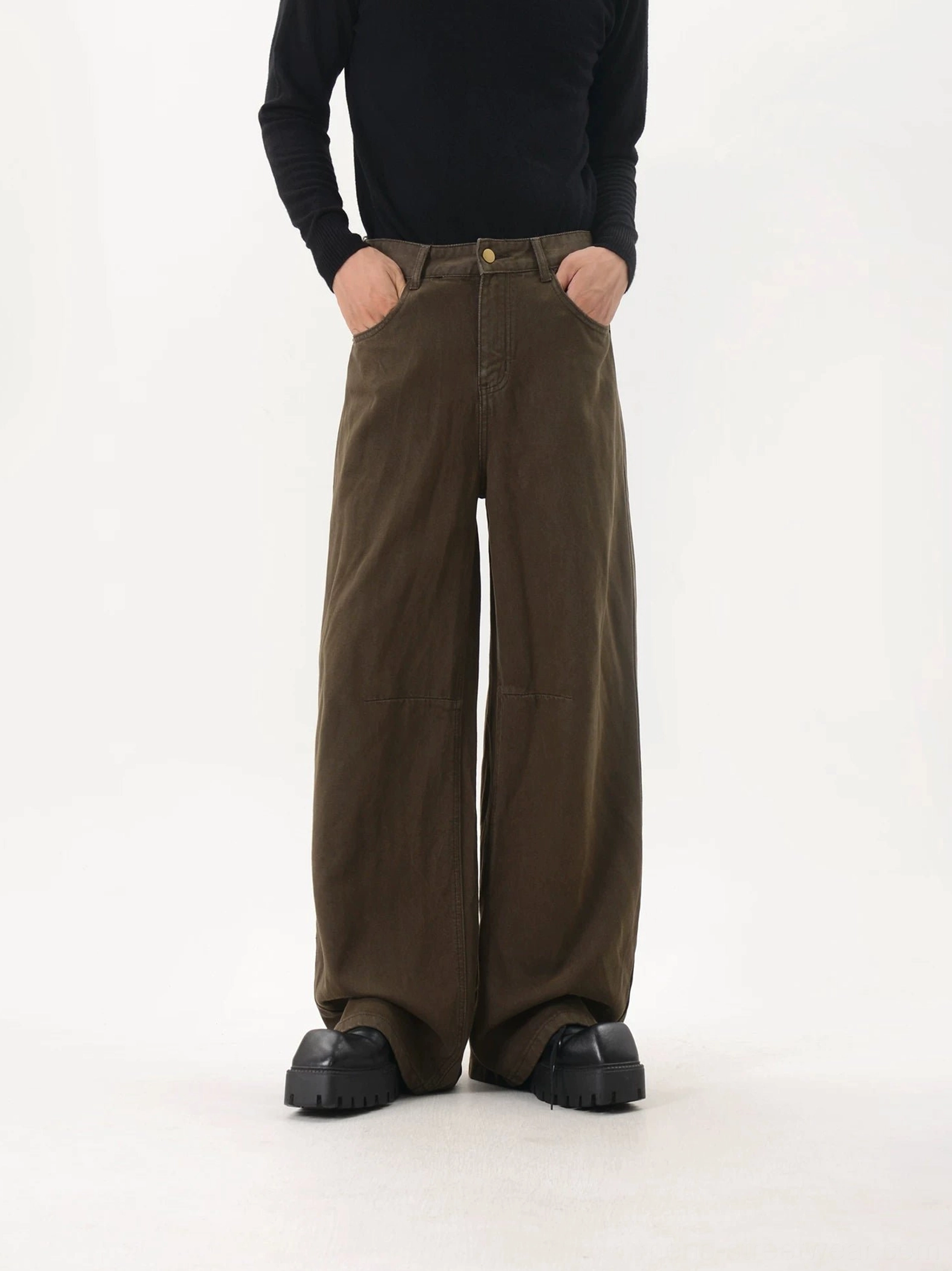 Front flat view of coffee brown washed wide-leg pants showing the long draped silhouette, front leg seam details, curved pockets, and vintage American streetwear finish