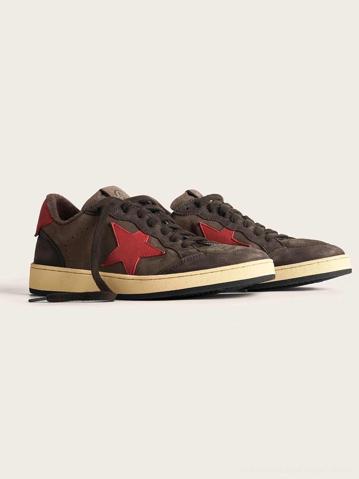Coffee and gray low-top star sneakers with an oversized graphic side panel and vintage-inspired rubber sole for everyday streetwear