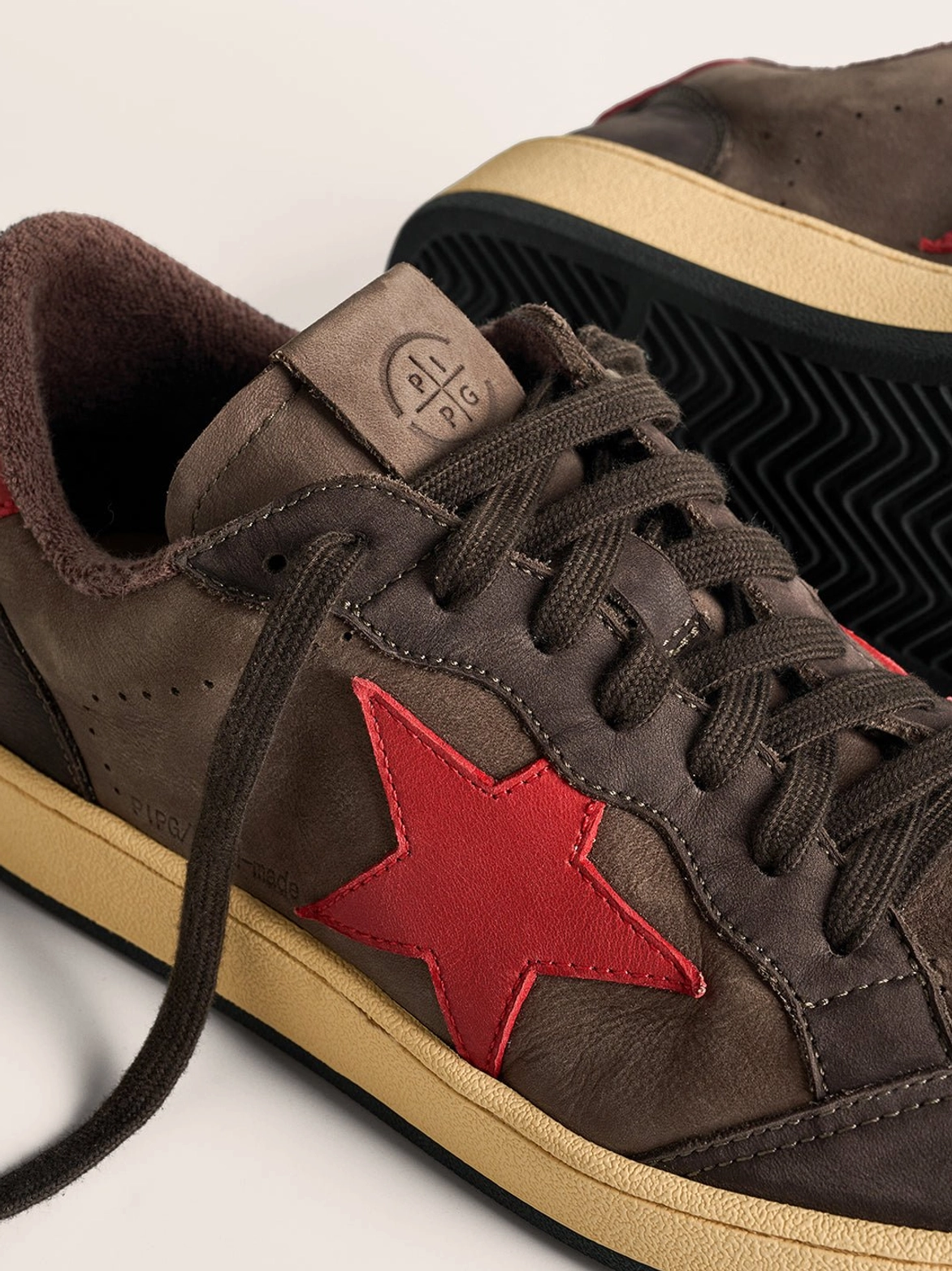 Retro coffee and gray star panel sneakers styled as versatile low-top streetwear shoes for denim, cargo pants, and oversized clothing