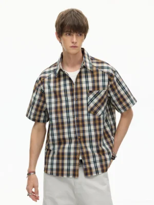 Front view of a coffee rust plaid short-sleeve button-down shirt with pointed collar and chest pocket