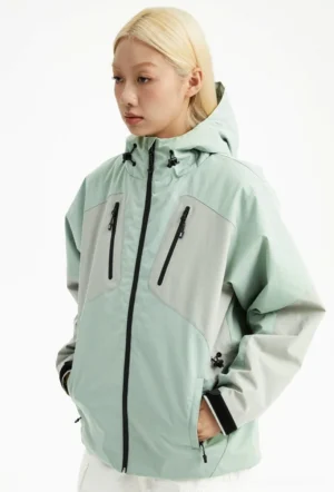 Mint green color-block hooded outdoor padded jacket shown from the front at a three-quarter angle with zippered chest pockets and adjustable hem