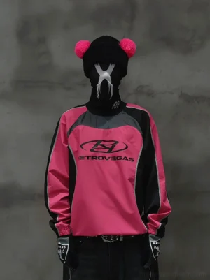 Hot pink and black color block racing raglan jersey styled with dark trousers and streetwear accessories