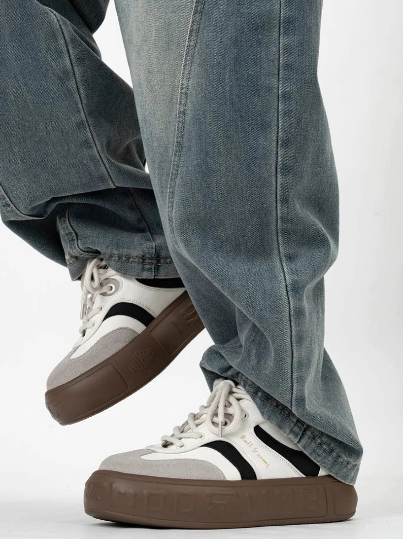 Color block skate inspired sneakers with contrast black side stripes low top lace up design and brown gum platform outsole worn with loose jeans