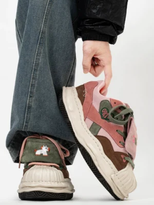 Rear side view of color-blocked suede-style shell-toe sneakers with green tongue pink laces horse embroidery and cream platform sole