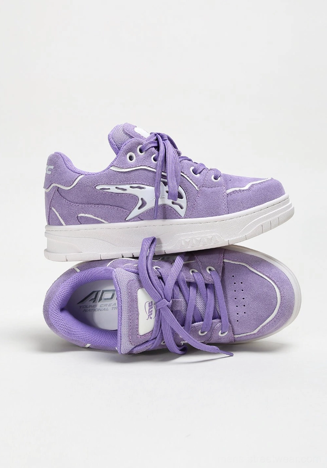 Contemporary skate-inspired sneakers featuring saturated colorways, padded low-top collar, graphic side detail, and flat outsole