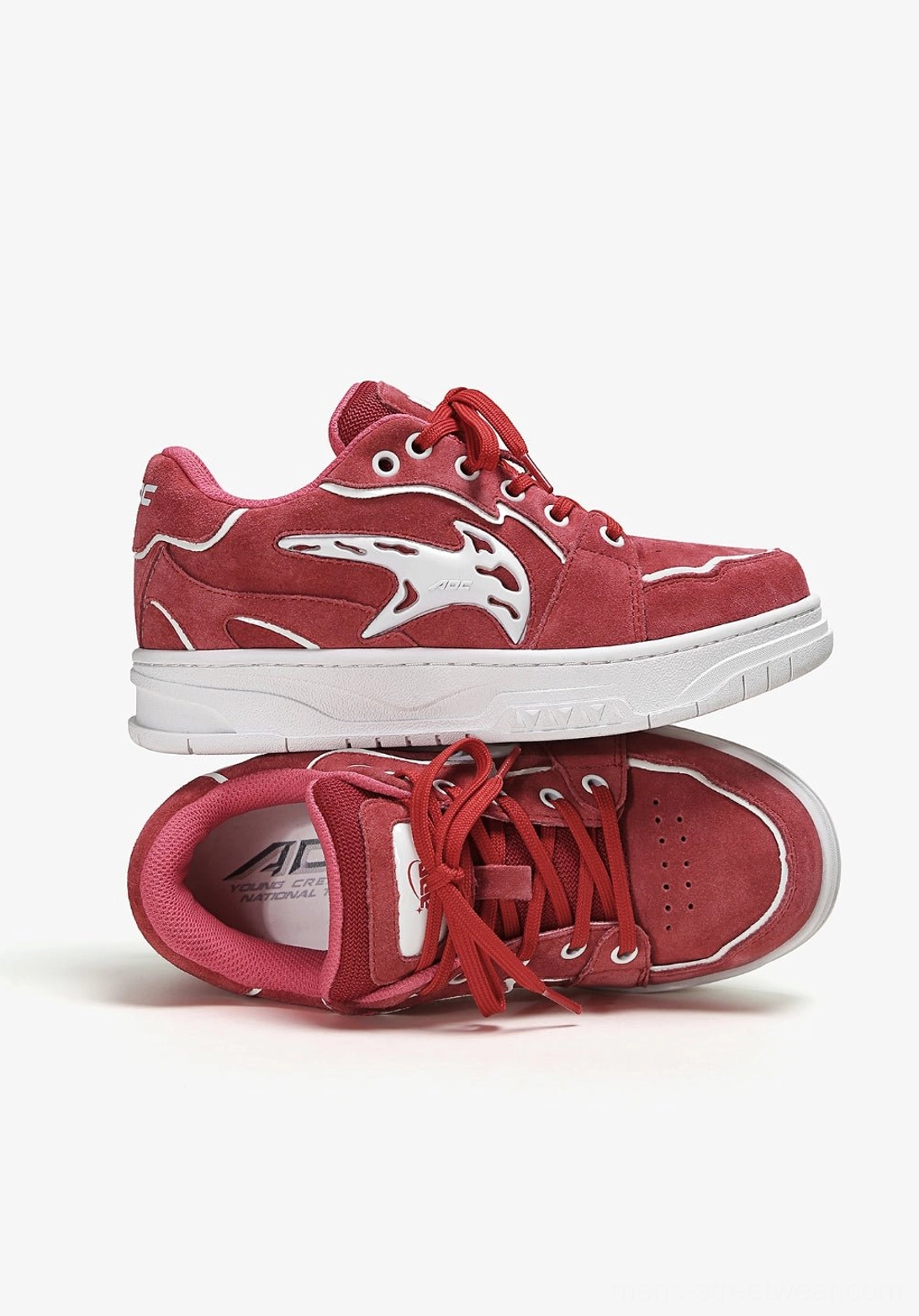 Stacked red color-pop low-top skate sneakers showing the textured upper, inner lining, insole area, and contrasting white rubber outsole
