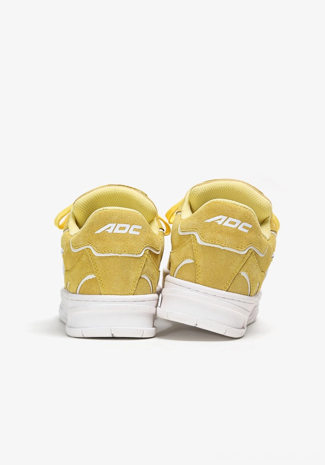 Statement low-top skate sneakers with saturated color blocking, textured paneled upper, matching laces, and clean white sole