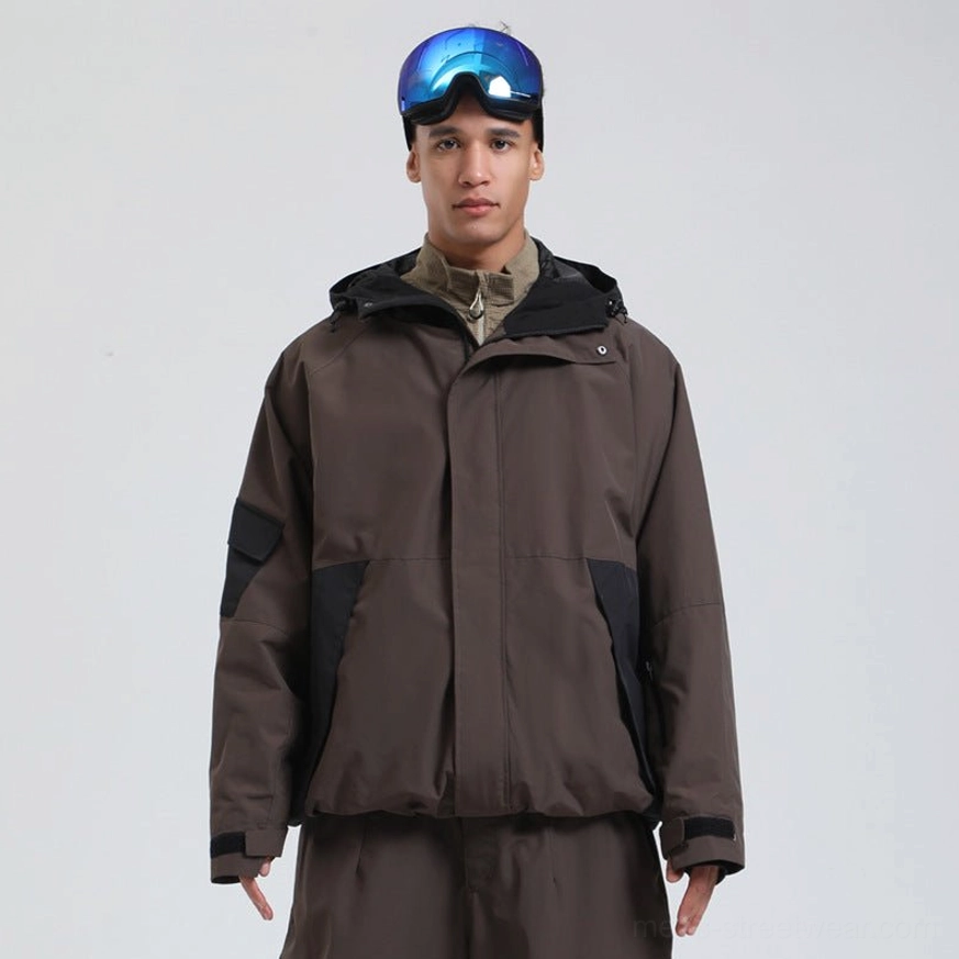 Dark brown and black colorblock snowboard shell jacket with hood, layered streetwear styling and dual front closure