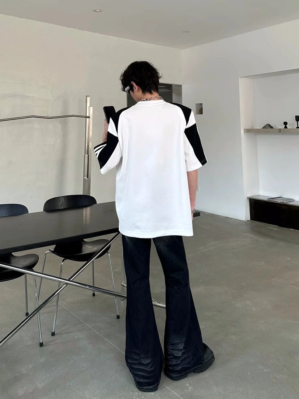 Back view of colorblock sport tee showing contrast panels and striped raglan-inspired sleeves